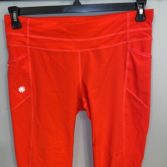 Athleta NWOT orange, thin leggings with side pockets, zip packet size Medium - Picture 2 of 7